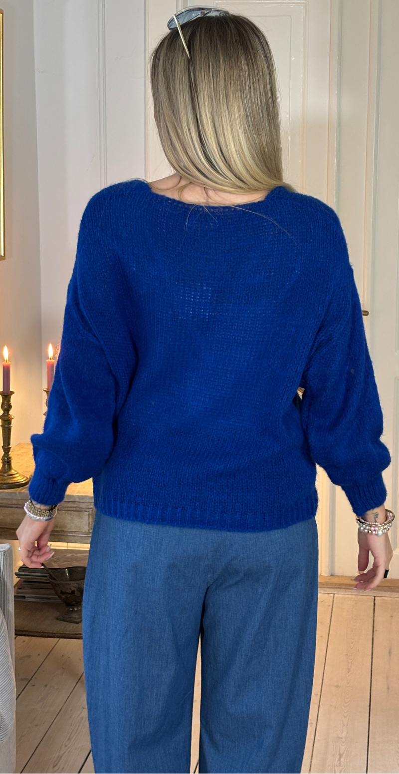 Zinka strik med lange ærmer og knude foran royal blue LikeLondon