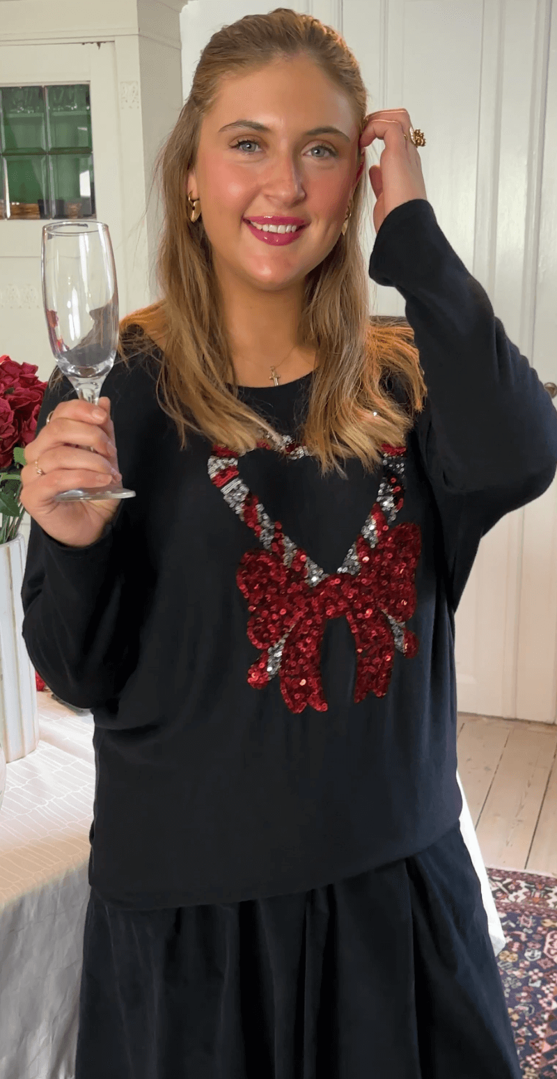 Madelene bluse med paillet sukkerstok og sløjfe sort LikeLondon