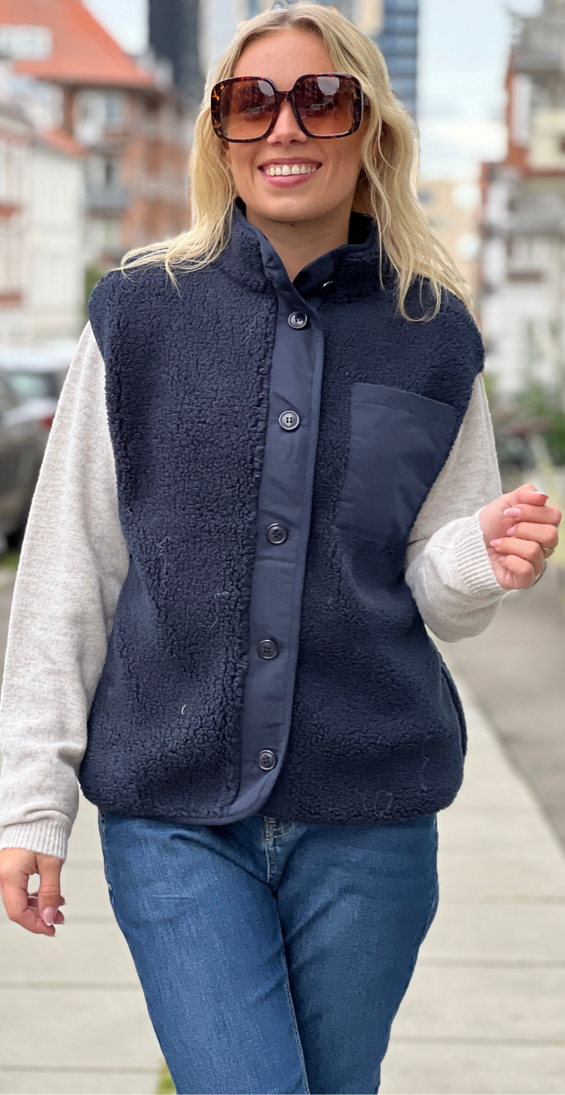 Kvinde i navy Onyx vest i teddy med brystlomme og knapper forfra fra LikeLondon.com