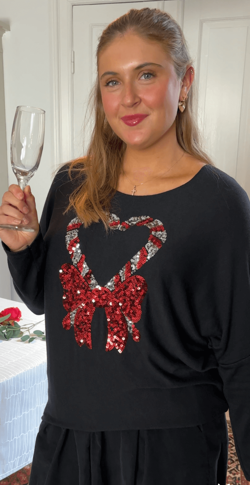 Madelene bluse med paillet sukkerstok og sløjfe sort LikeLondon