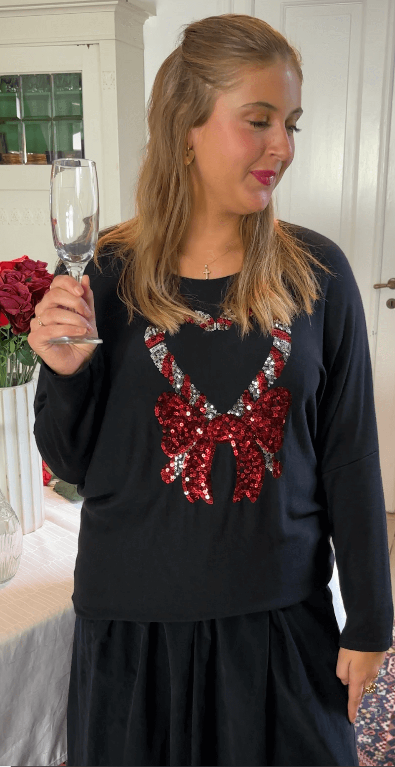 Madelene bluse med paillet sukkerstok og sløjfe sort LikeLondon